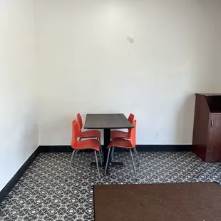 a table and chairs in a small room