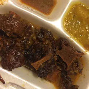 Oxtail. And she charged extra because she put &quot;double portion&quot;, there is still barely anything there