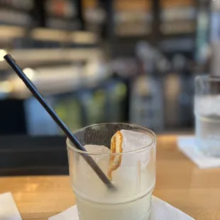 a glass of water with a spoon in it