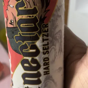 a hand holding a can of kaneohe