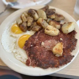 Cornbeef hash and eggs with family style potatoes