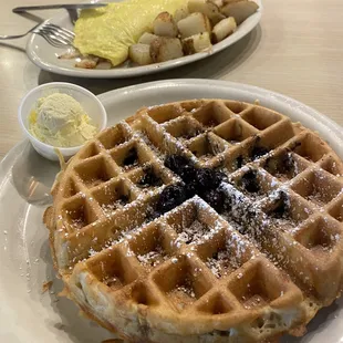Veggie omelette (oily, undercooked vegetables, watery eggs, salty potatoes) and Blueberry waffle (frozen blueberries, soggy, no flavor)
