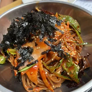 a bowl of noodles with seaweed