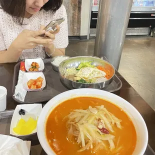 a woman eating a bowl of soup