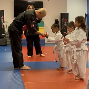 Master Kang handing my daughter her new belt
