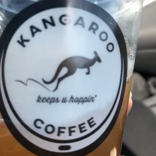 a hand holding a cup of coffee