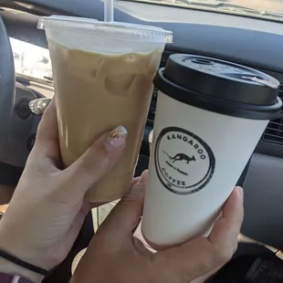a hand holding a cup of coffee