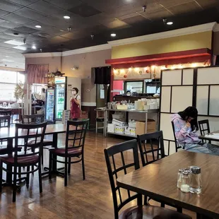 a woman sitting at a table in a restaurant