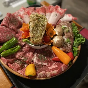 a platter of meat and vegetables