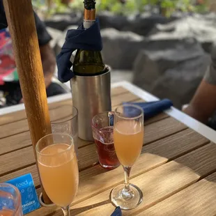 two glasses of wine and a bottle of wine