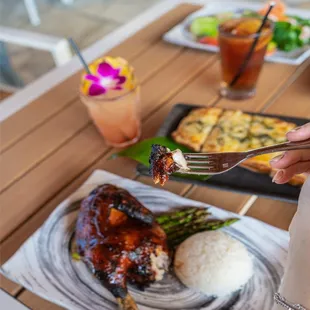a person holding a fork over a plate of food