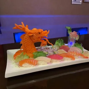 Hand curving dragon head use the carrot.  Check ours sushi chefs nice jobs.