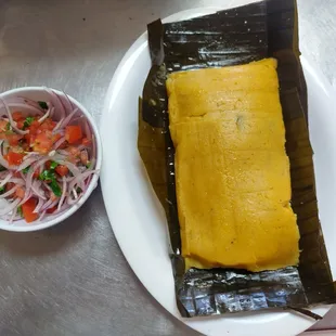 a fish wrapped in a banana leaf