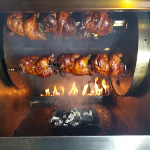 a chicken being cooked on a grill