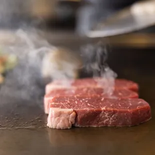 a steak being cooked on a grill