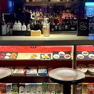 a sushi bar with plates of food