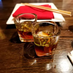 two glasses of tea and chopsticks on a table