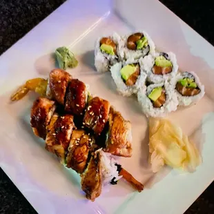 a plate of sushi and rolls
