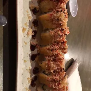 Yum yum roll - tempura shrimp, cream cheese, seasame, deep fried topped with shrimp, crab, yum yum sauce, and eel sauce
