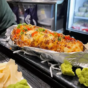 a hot dog with cheese and vegetables
