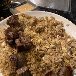 Filet mignon and chicken with fried rice and a side of yum yum sauce