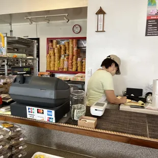 a woman working behind the counter