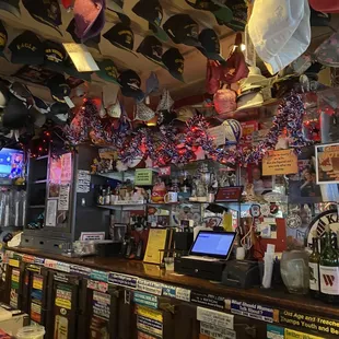 a variety of hats hanging from the ceiling