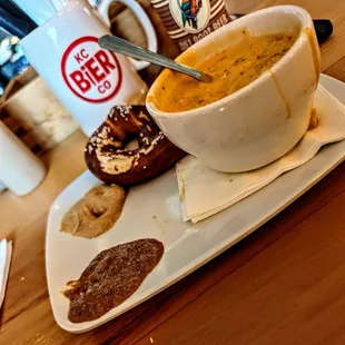 Sweet and yellow/bitter mustard, small pretzel, beer cheese soup