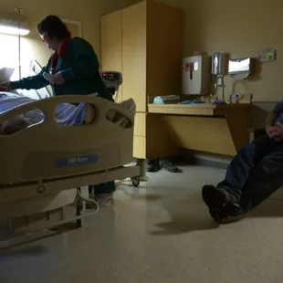 A nurse gives a patient a thermometer. Blood pressure next.