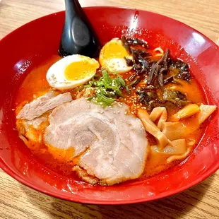 Spicy tonkatsu ramen - toppings include: bamboo shoots, pork, egg, sliced wood ear mushroom, scallions with sesame seeds