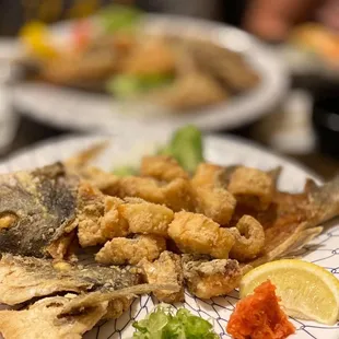 a plate of fried fish and vegetables