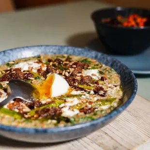 Savory Grain Porridge with Runny Egg and Bacon Bits (+$2 respectively)