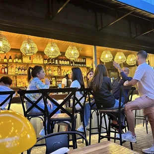 a group of people sitting at a bar