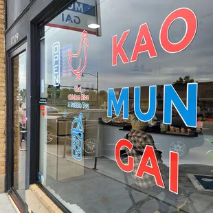 a man sitting in a chair in front of a store window