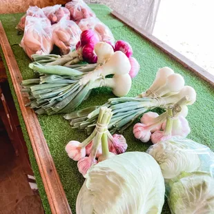 From left to right: Potato's, onions, garlic, and cabbage.