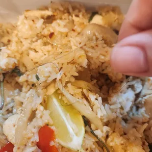 a hand picking up a piece of rice