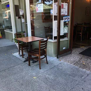Empty sidewalk tables.