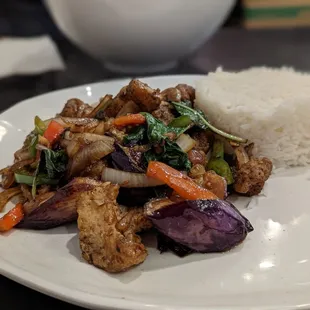 Fish filet and eggplant with basil leaves