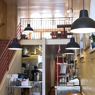 Upstairs dining on top of kitchen. Cashier in front of kitchen.