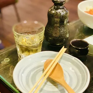 chopsticks and a plate of food on a table