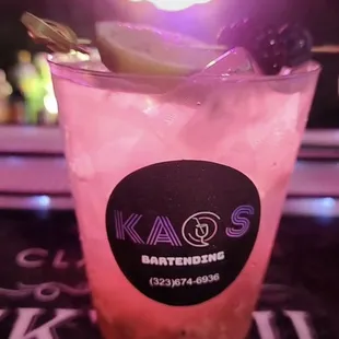 a pink drink with a slice of lime