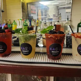 a variety of cocktails on a bar