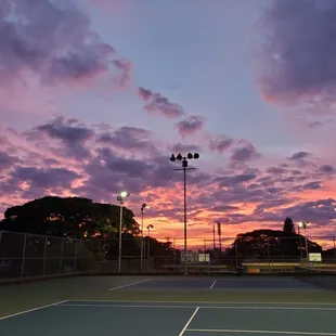 The tennis courts have lights for evening play.