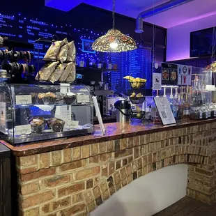 a coffee shop with a brick counter