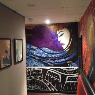 a hallway with a mural on the wall