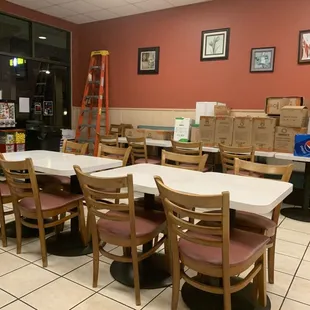 This is so sad.......a ladder and supply boxes stacked lined up in the seating banquettes? WHO wants to eat this environment ?