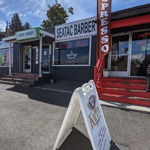 a sign in front of a barber shop