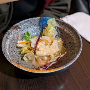 Remains of a side salad that comes standard with the rice-based meals. Phenomenal mix and dressing.