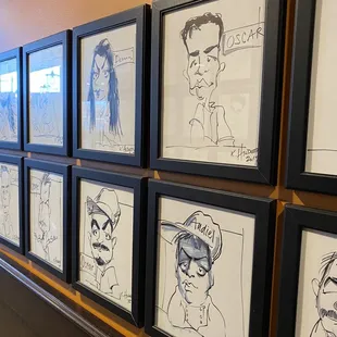 Caricatures in the bathroom hallway