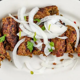 a plate of meat and onions